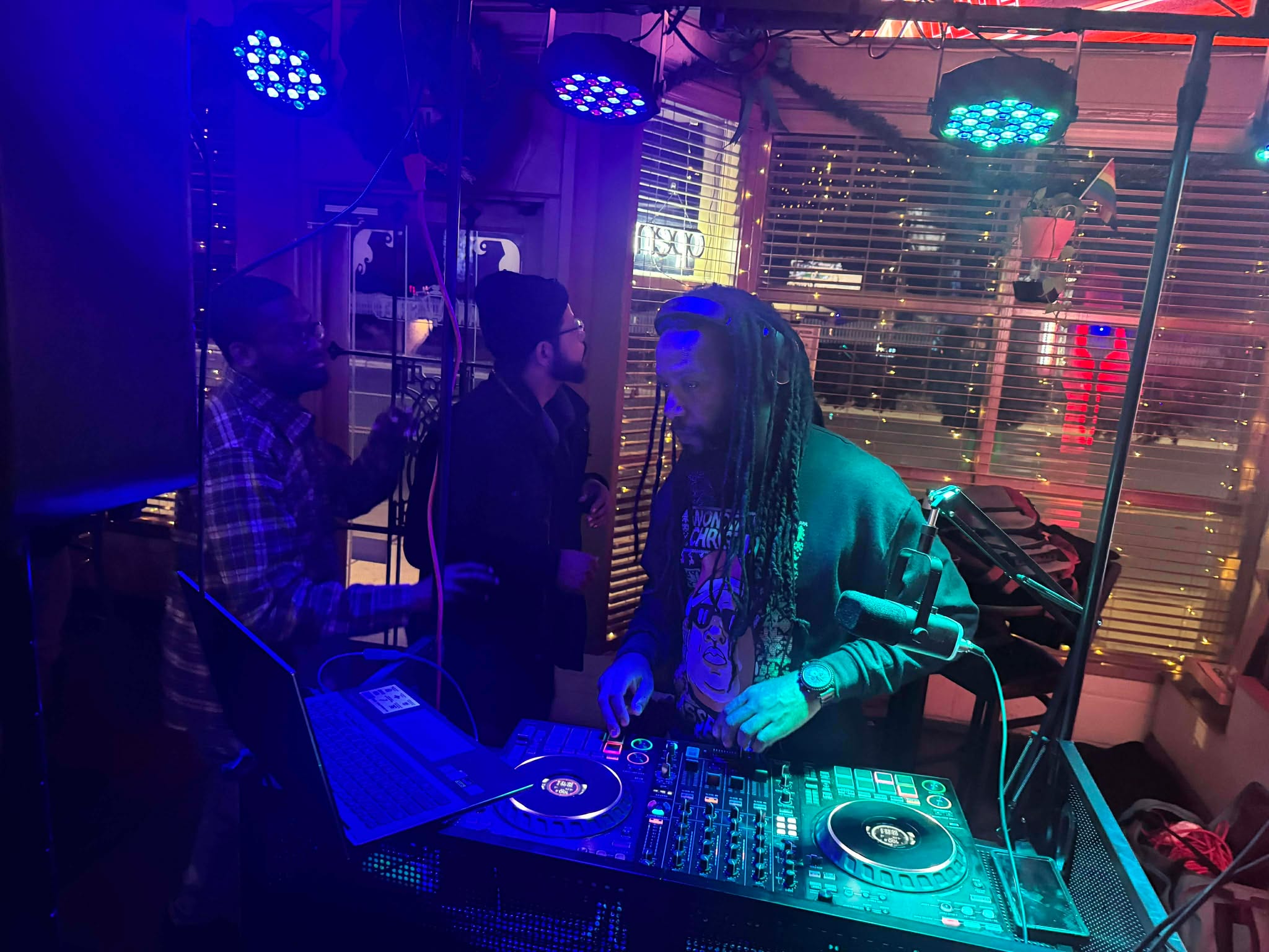 DJ Mandatory performing with blue and purple lights