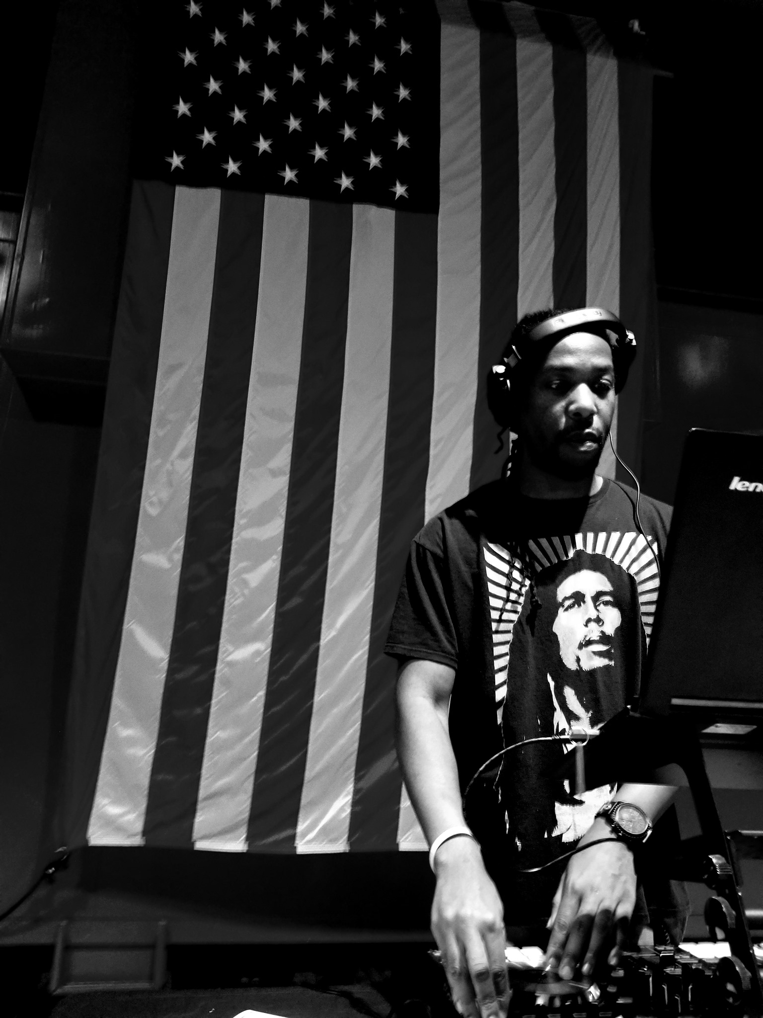 DJ Mandatory with American flag backdrop black and white